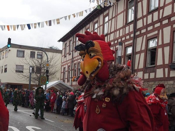 Narren mit Hahnenmasken beim Fasnetsumzug in Neuhausen