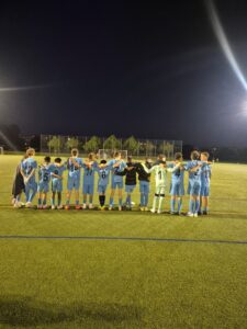 Die C-Jugend des TV Kemnat steht Arm in Arm am Spielfeldrand unter Flutlicht beim Elfmeterschießen